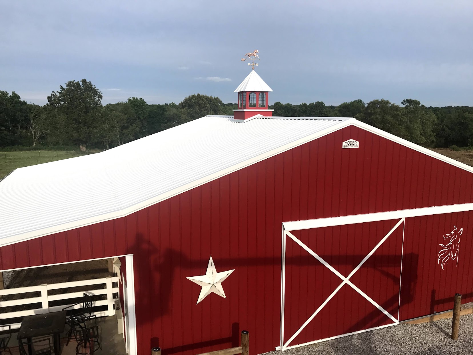 Same red barn with cupola and weathervane installed